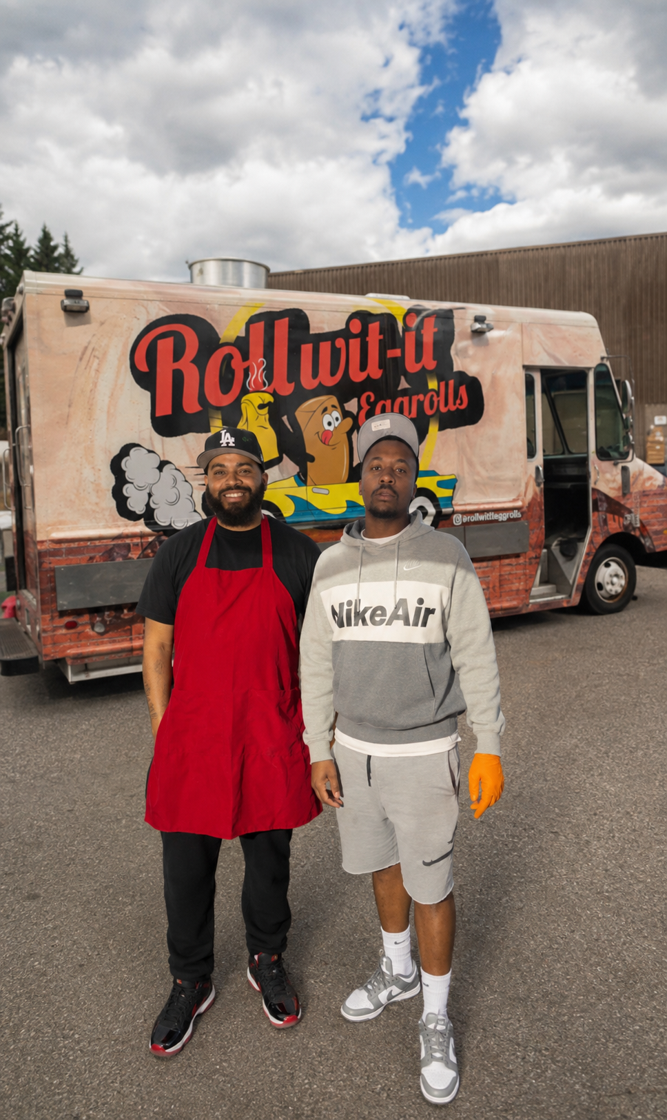 Two Roll Wit-it team members standing in front of the Roll Wit-it food truck